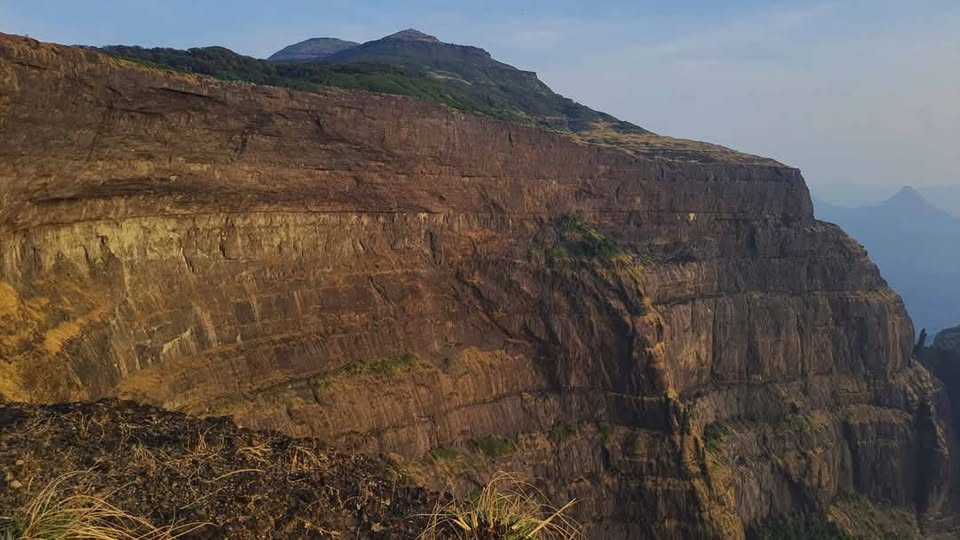 Majestic rocky cliff under clear blue sky