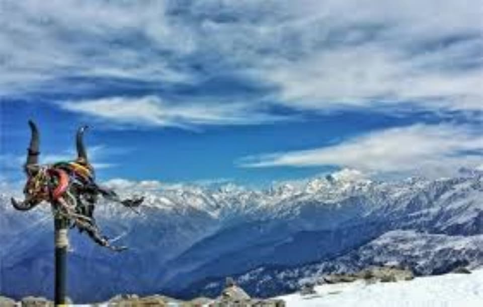 Snowy mountains with prayer flags and blue sky