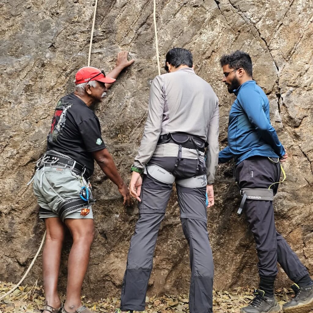 Rock climbers inspecting a rock face