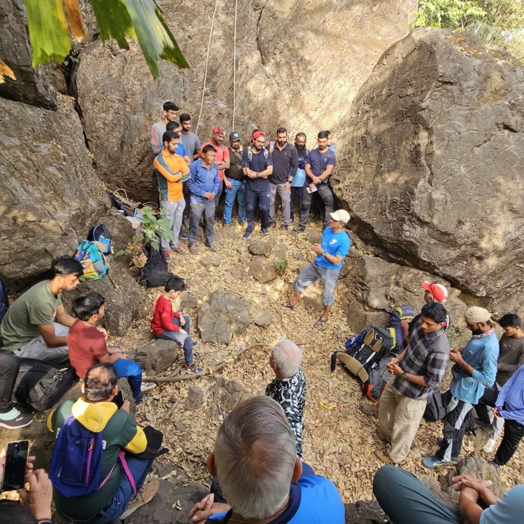 Group meeting outdoors near large rocks