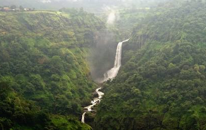 Lush green valley with cascading waterfall