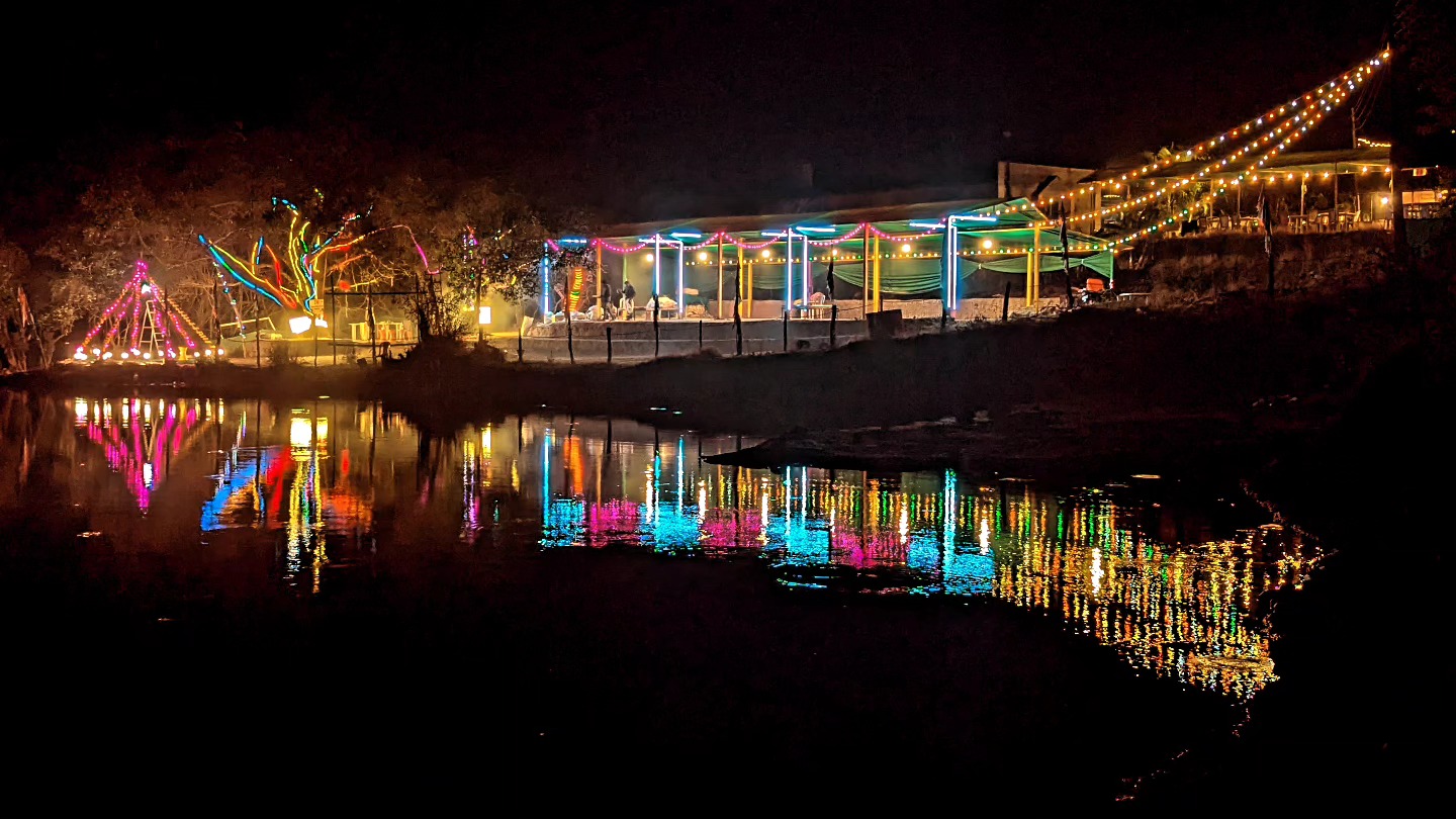 Colorful lights reflecting on a lake at night.