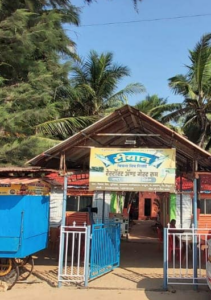 Outdoor restaurant with palm trees and chairs.