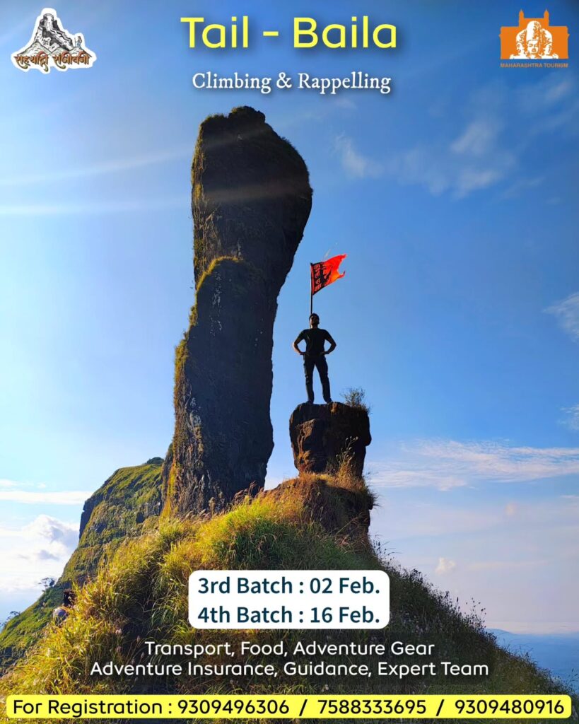 Man on peak with flag, Tail-Baila climbing event.