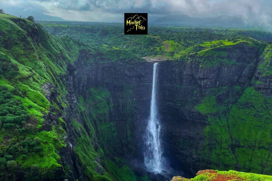 Scenic waterfall cascading in lush green valley