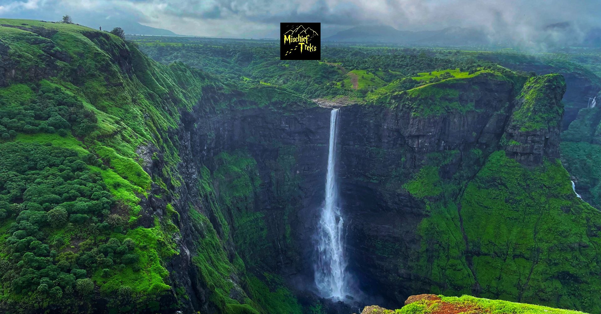Scenic waterfall cascading in lush green valley