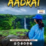 Person enjoys waterfall view on jungle trek.