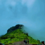 Mountain view with temple and foggy landscape.