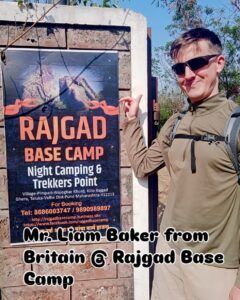 Person pointing at Rajgad Base Camp sign