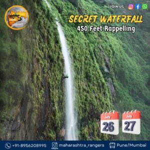 Person rappelling down a tall waterfall.