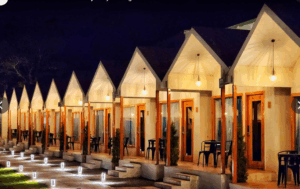 Row of illuminated cabins at night.