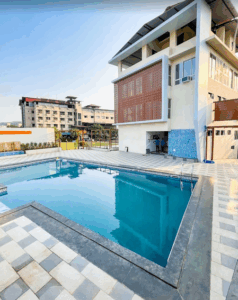 Modern building with pool in front.