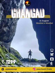 Person standing between rocks at Ghangad Fort.