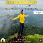 Person enjoying mountaintop view at Harishchandragad.