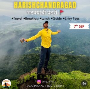 Person enjoying mountaintop view at Harishchandragad.