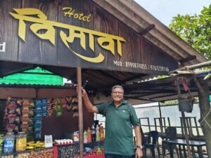 Smiling man outside Indian snack shop