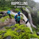 Group rappelling at waterfall, August 2025 event.