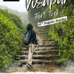 Person hiking Visapur Fort trek under misty conditions.