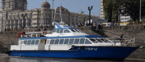 Blue and white boat docked near historic building