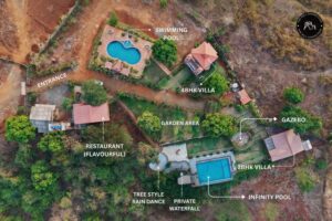 Aerial view resort layout with villas and swimming pools.