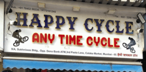 Happy Cycle store sign with contact details