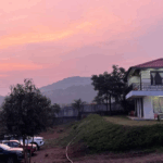 Hilltop building at sunset with pink sky