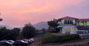Hilltop building at sunset with pink sky