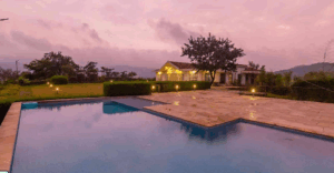 Serene villa with pool at sunset.