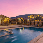 Resort pool and buildings at sunset