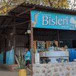 Roadside snack shop with Bisleri sign in India.