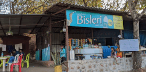 Roadside snack shop with Bisleri sign in India.