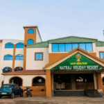 Natraj Holiday Resort entrance with parked vehicles