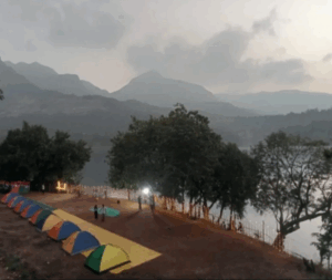 Colorful tents by a lakeside at dusk.