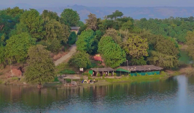 lakeside campin Lakeside view of forest and small buildings.