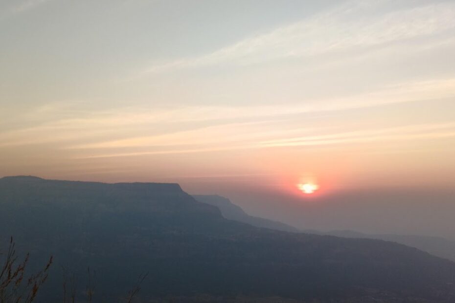 Sunset over misty mountains and horizon