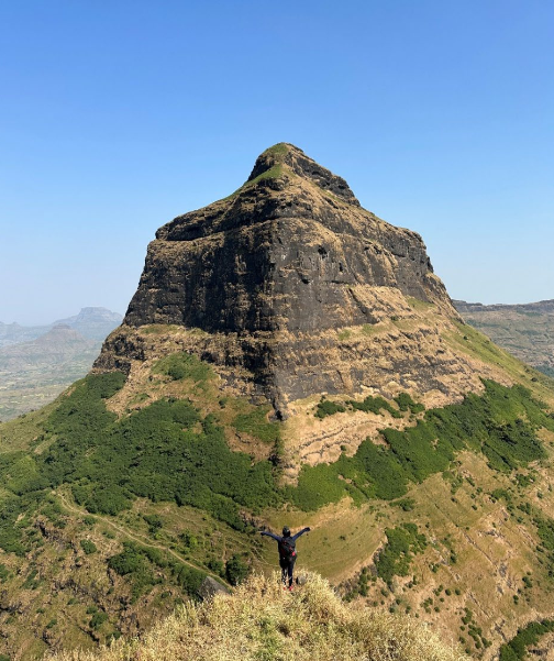salher fort Hiker triumphs on lush mountain summit